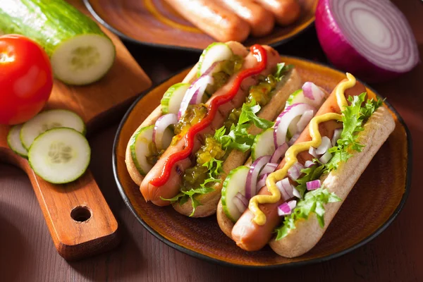 Grilled hot dogs with vegetables ketchup mustard — Stock Photo, Image