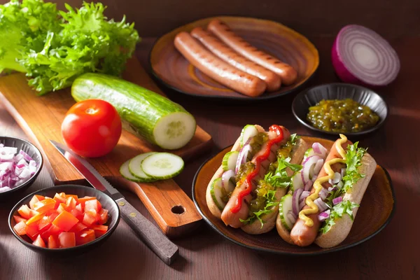 Grilled hot dogs with vegetables ketchup mustard — Stock Photo, Image