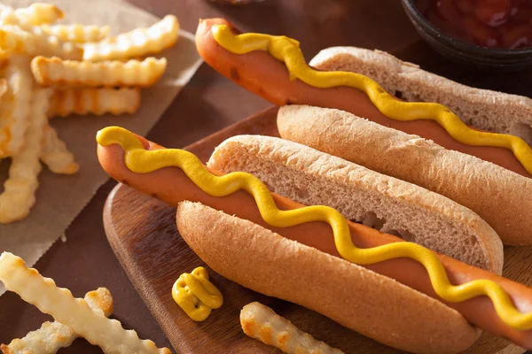 Grilled hot dogs with mustard and french fries — Stock Photo, Image