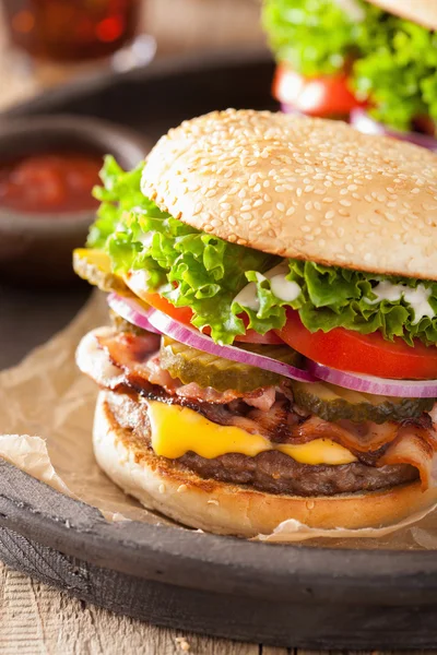 Bacon cheese burger with pickles tomato onion — Stock Photo, Image