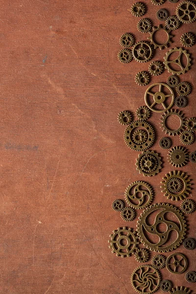 Steampunk mechanical cogs gears wheels on wooden background — Stock Photo, Image