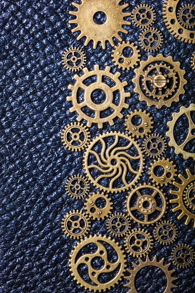 steampunk mechanical cogs gears wheels on leather background