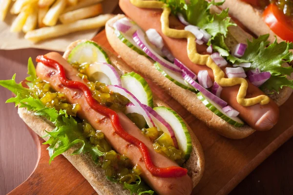 Grilled hot dogs with vegetables ketchup mustard — Stock Photo, Image