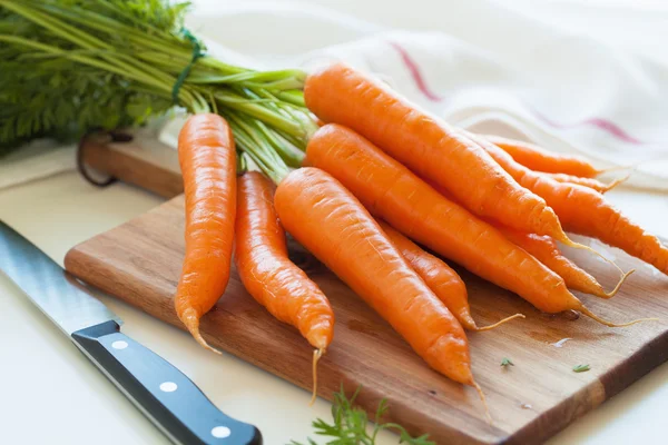 Verdure crude di carota su tagliere di legno — Foto Stock