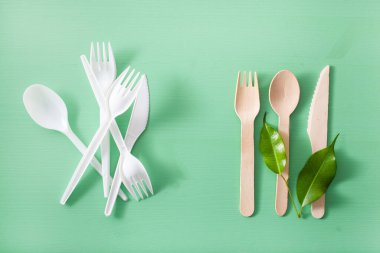 harmful plastic cutlery and eco friendly wooden cutlery. plastic free concept clipart