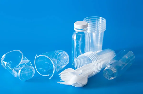 single use plastic cups, forks, spoons. concept of recycling plastic, plastic waste