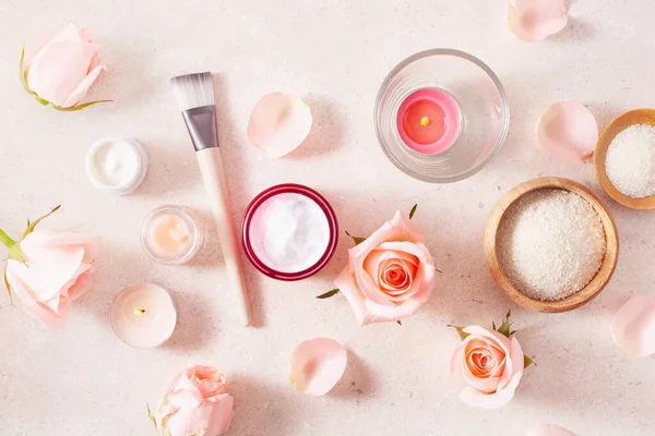 skincare products and rose flowers. natural cosmetics for home spa treatment