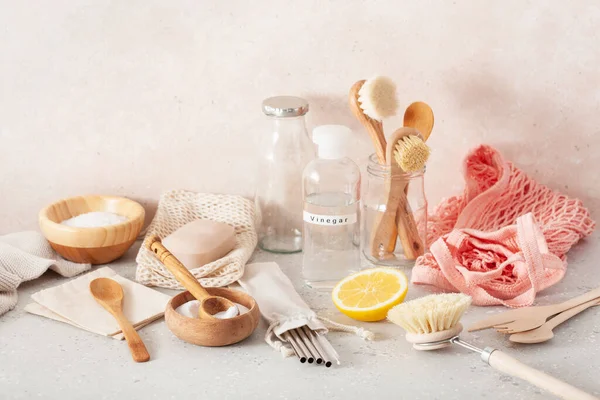 zero waste eco friendly cleaning kitchen concept. wooden brushes, lemon, baking soda, vinegar, drinking straw