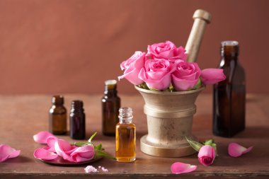 spa and aromatherapy set with rose flowers mortar essential oils clipart