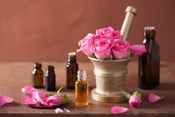 spa and aromatherapy set with rose flowers mortar essential oils