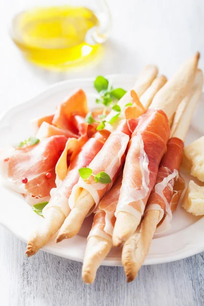 Prosciutto ham and grissini bread sticks. italian antipasto — Stock Photo, Image