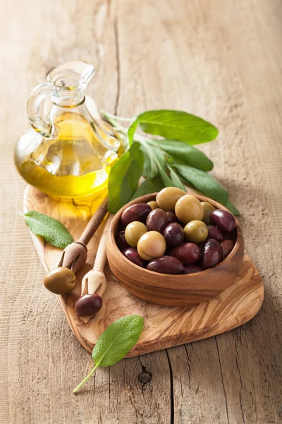 Black and green marinated olives oil sage leaf — Stock Photo, Image