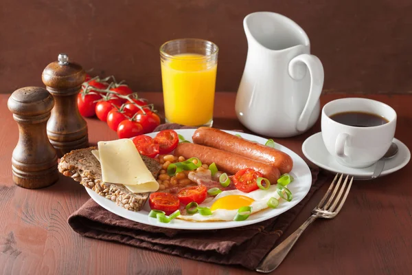 English breakfast with fried egg sausages bacon tomatoes beans — Stock Photo, Image