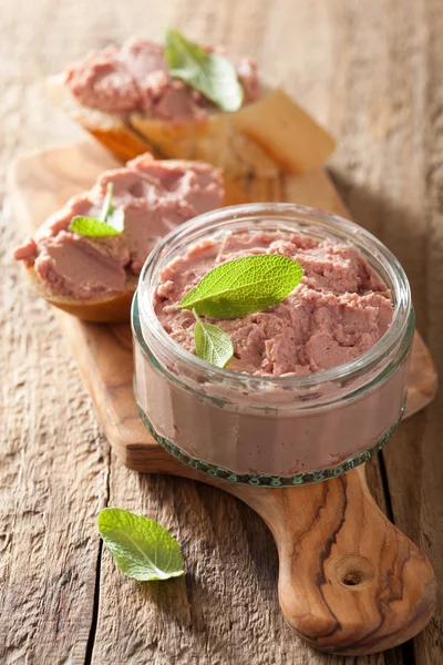 Healthy chicken liver pate with sage in jar and on bread — Stock Photo, Image