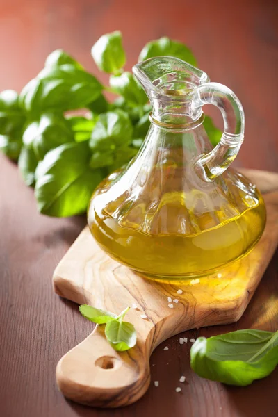 Fresh basil leaves herb and olive oil on wooden bacgkround — Stock Photo, Image