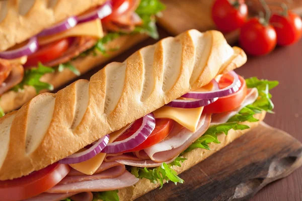 Long baguette sandwich with ham cheese tomato and lettuce — Stock Photo, Image