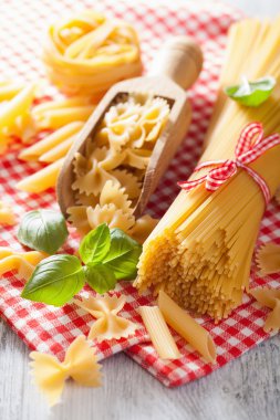 raw pasta farfalle spaghetti penne tagliatelle. italian cuisine