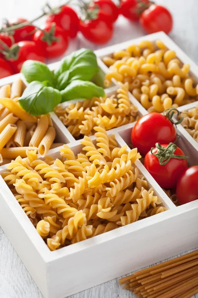 Various raw wholegrain pasta in white wooden box — Stock Photo, Image