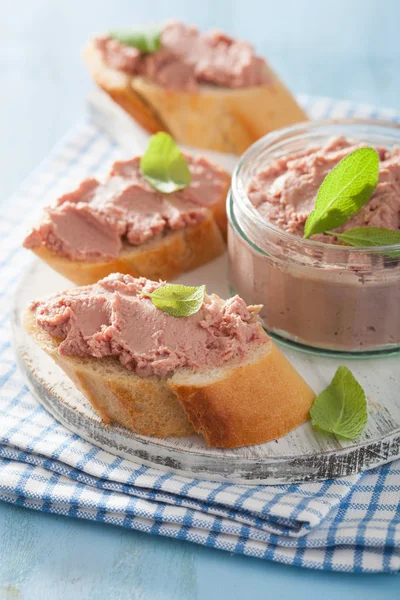 Healthy chicken liver pate with sage in jar and on bread — Stock Photo, Image