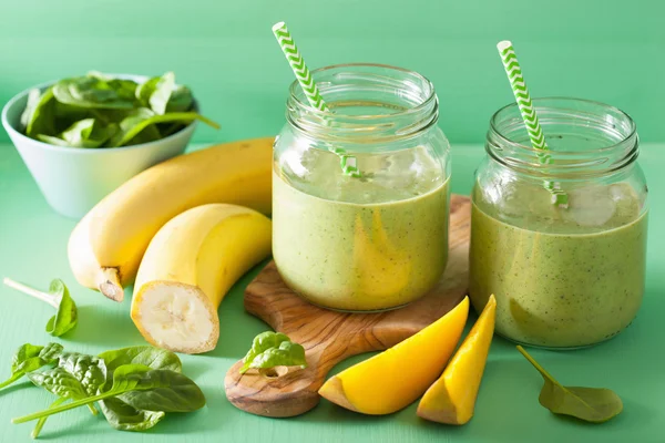 Healthy green smoothie with spinach mango banana in glass jars — Stock Photo, Image