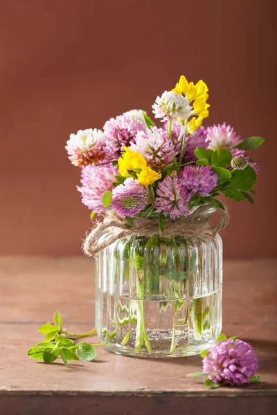 Colorful medical flowers and herbs in glass jar — Stock Photo, Image