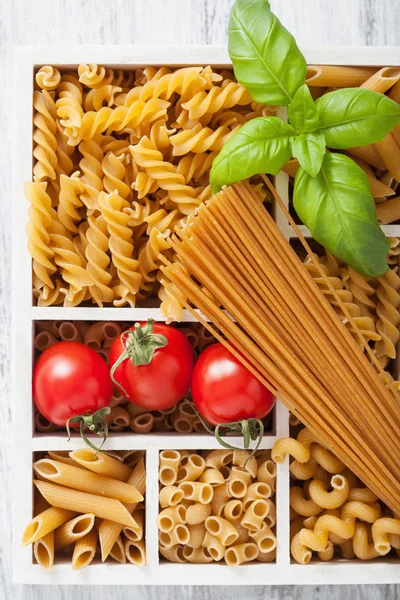 Various raw wholegrain pasta in white wooden box — Stock Photo, Image