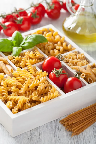 Various raw wholegrain pasta in white wooden box — Stock Photo, Image