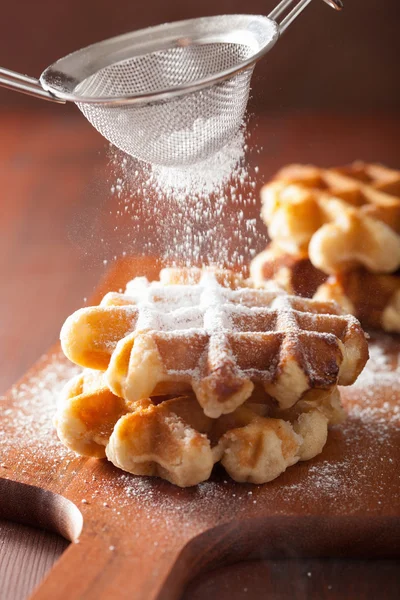 Belgian waffles sprinkled with icing sugar — Stock Photo, Image