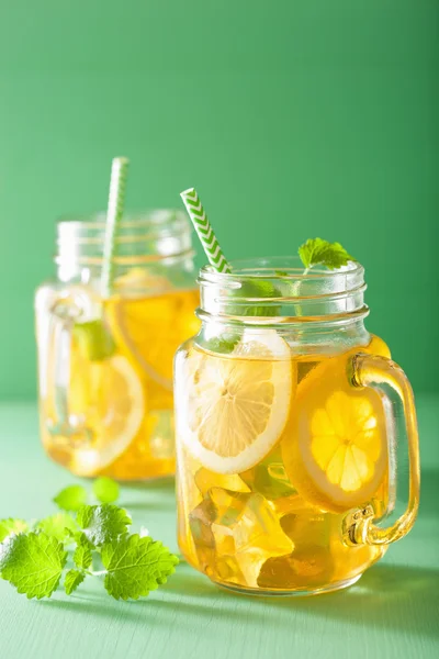 Ice tea with lemon and melissa in mason jars — Stock Photo, Image