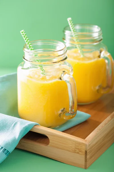 Healthy yellow smoothie with mango pineapple banana in mason jar — Stock Photo, Image