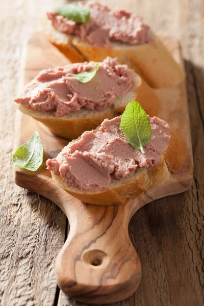 Healthy chicken liver pate with sage in jar and on bread — Stock Photo, Image