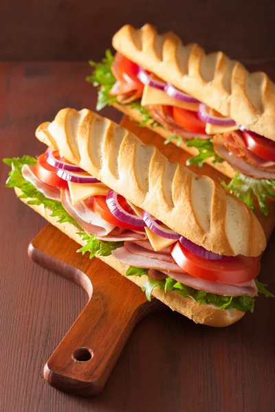 Long baguette sandwich with ham cheese tomato lettuce — Stock Photo, Image