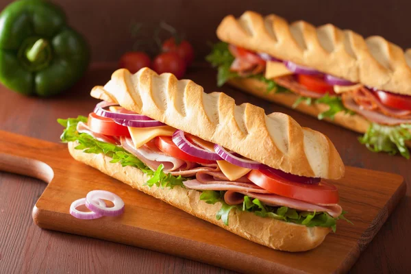 Long baguette sandwich with ham cheese tomato lettuce — Stock Photo, Image