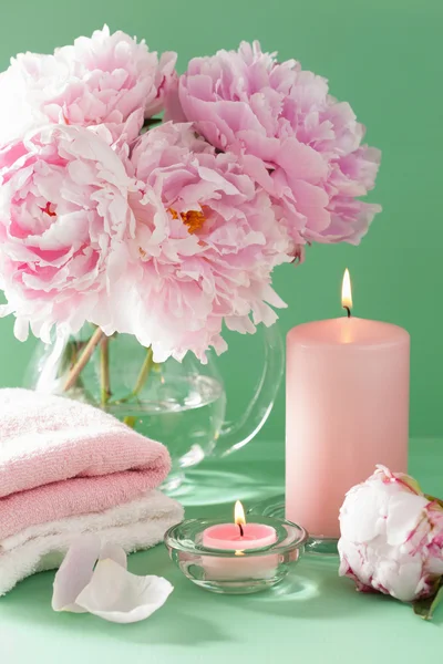 Bath and spa with peony flowers candles towels — Stock Photo, Image