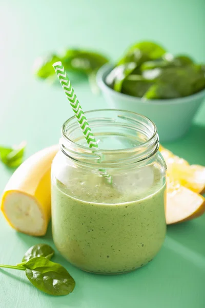 Healthy green spinach smoothie with mango banana in glass jar — Stock Photo, Image