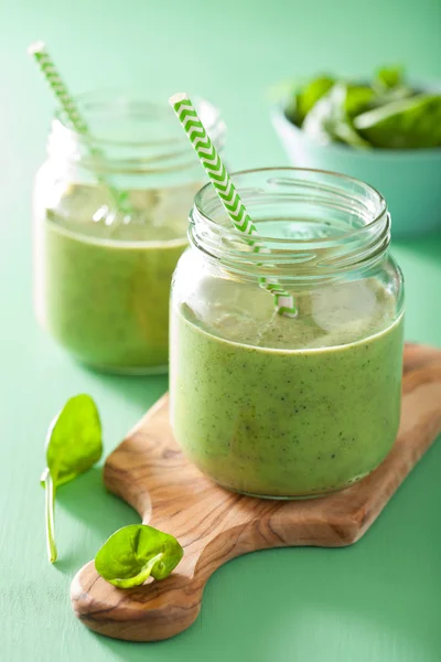 Healthy green spinach smoothie with mango banana in glass jar — Stock Photo, Image