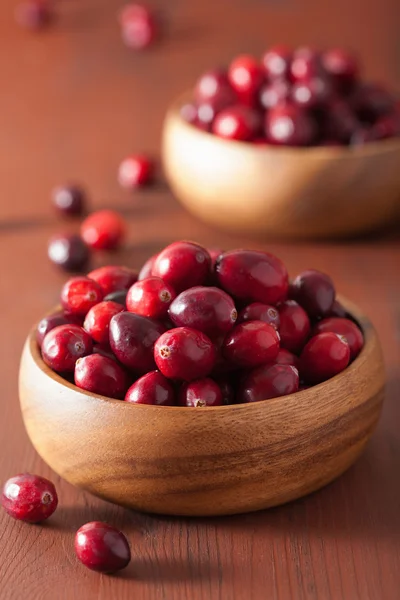 Fresh cranberry in wooden bowls over rustic table — Stock Photo, Image