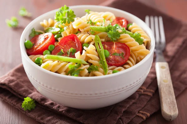 Vegetariánské těstoviny fusilli s bylinkami hrachu, rajčat — Stock fotografie