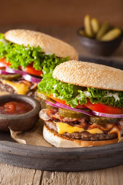 Bacon cheese burger with pickles tomato onion — Stock Photo, Image