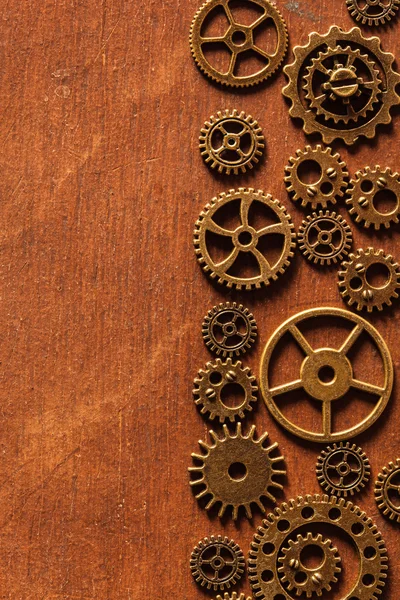 Steampunk mechanical cogs gears wheels on wooden background — Stock Photo, Image