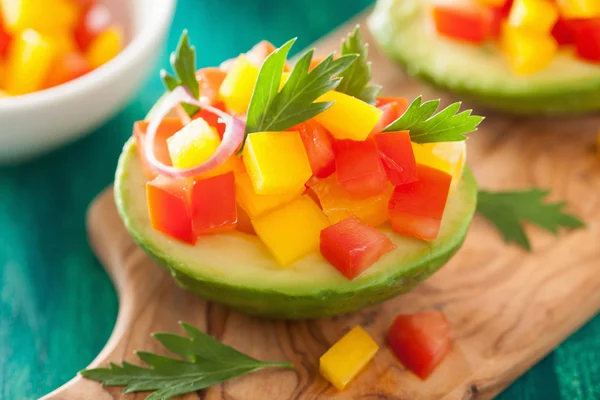 Avocados stuffed with tomato pepper salad — Stock Photo, Image