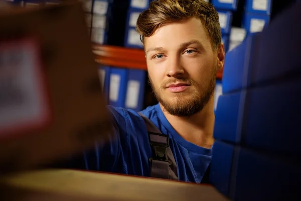 Worker on a automotive spare parts warehouse