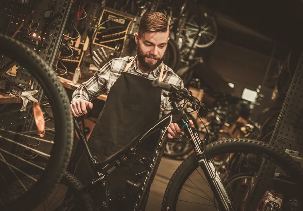 Stylish bicycle mechanic — Stock Photo, Image