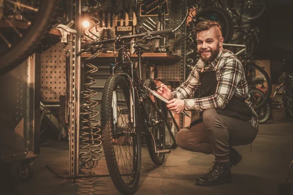 Stylish bicycle mechanic — Stock Photo, Image