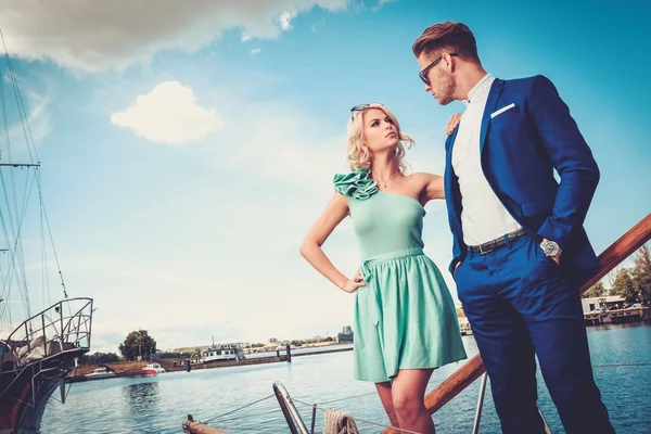 Stylish wealthy couple on a luxury yacht — Stock Photo, Image