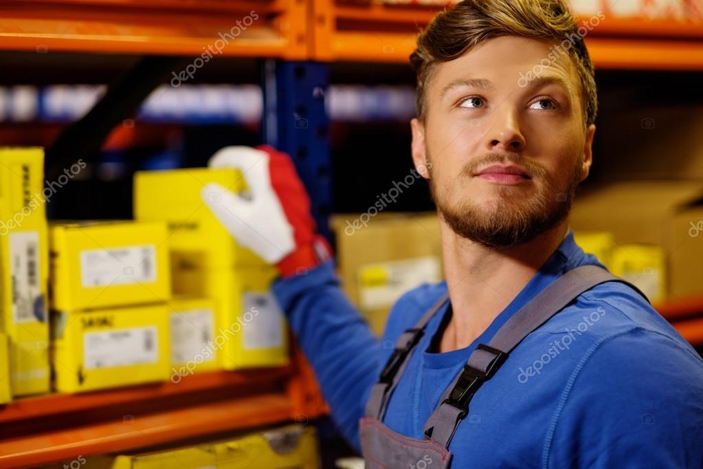 Worker on a automotive spare parts warehouse — Stock Photo © nejron