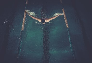 Man swims using breaststroke technique  clipart