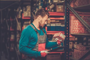 Worker on a automotive spare parts warehouse  clipart