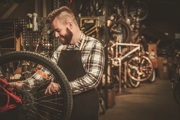 Stylish bicycle mechanic — Stock Photo, Image