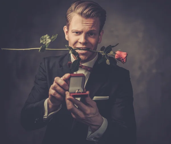 Man holding box with a proposal ring and red rose — Stock Photo, Image